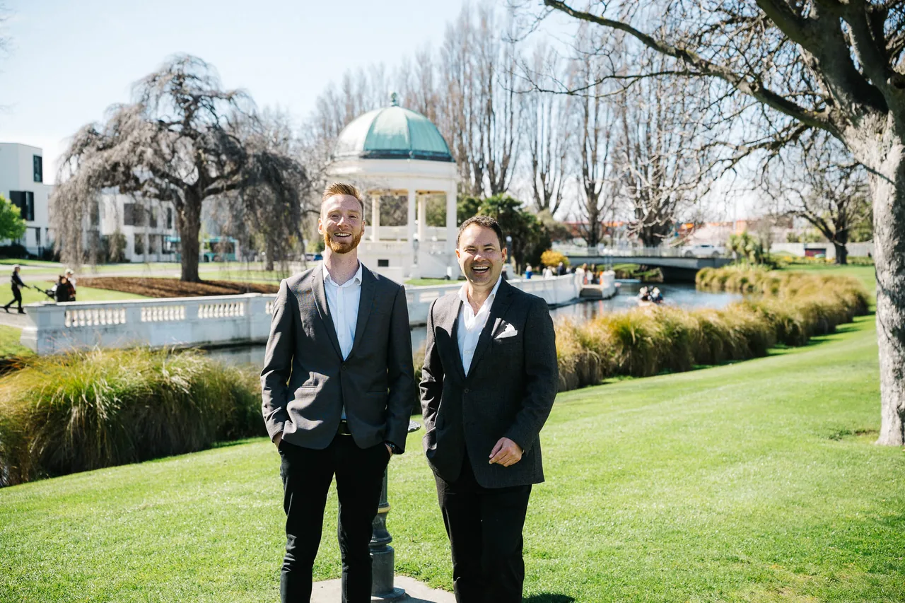 Mitch van der Weert and Jonathan Liong by the rotunda in a Christchurch riverside park